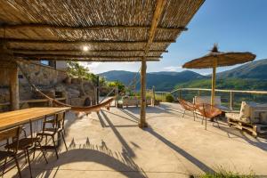 a patio with a hammock and a view of mountains at Cerrás Agroturismo in Jerte