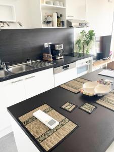 a kitchen with a black and white counter top at Rare ***Centre ville * Parking in Montpellier