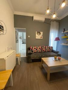 a living room with a couch and a table at Studio 7 in Thessaloniki