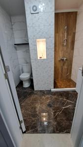 a bathroom with a shower and a toilet and a sink at Diamond Beach Luxus Apart Obzor 28 in Obzor