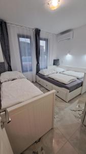 a bedroom with two beds and a window at Diamond Beach Luxus Apart Obzor 28 in Obzor