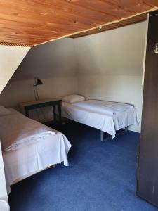 a room with two beds and a wooden ceiling at Rural in Assens