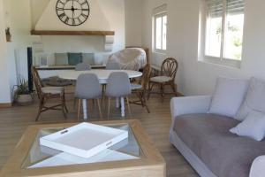 a living room with a couch and a table at Logement privée in La Teste-de-Buch