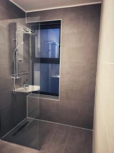 a bathroom with a glass shower and a sink at Olea Vitis in Međugorje