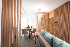 a living room with a couch and a table at Mountain Breeze ApartTerrace in Braşov