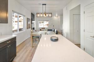 a kitchen with a white counter top and some tables at FLG Retreat in Flagstaff