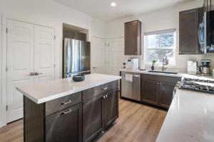 a large kitchen with wooden floors and stainless steel appliances at FLG Retreat in Flagstaff