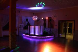 a purple room with a stage with purple lights at Kardamon in Żary