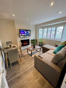 a living room with a couch and a tv at Paul Properties in Ruislip