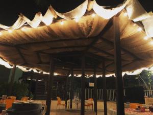 a large wooden umbrella with lights on a patio at Casa Real Palo Gacho in Emiliano Zapata