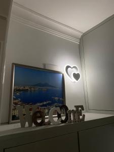 a living room with a tv and a table with alevision at Casa vacanze Figurelle in Naples