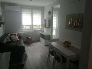 a living room with a couch and a table at RsG Home in Keszthely