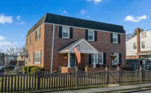 a brick house with a fence in front of it at Garrett Hill in Bryn Mawr