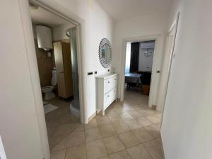 a bathroom with a toilet and a sink and a mirror at Apartma Zonta in Sečovlje +13 photos