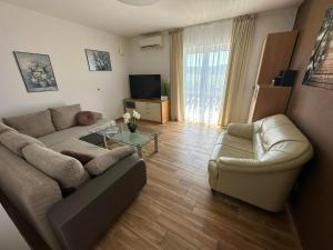 - un salon avec un canapé et une table dans l'établissement Apartma Zonta, à Sečovlje