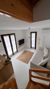 a white room with a bed and two windows at Villa Usignolo in Lignano Sabbiadoro