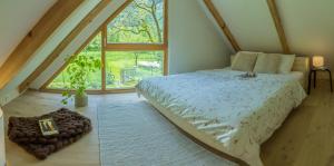 a bedroom with a bed and a large window at Tiny Eko House Bovec in Bovec