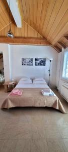 a large bed in a room with a wooden ceiling at BaLoRo apartment in Mokošica