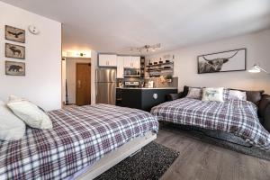 een slaapkamer met 2 bedden en een keuken bij Iron Horse C3013 condo in Winter Park