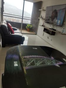 un soggiorno con divano e TV di penthouse a Bello