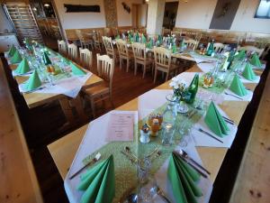a group of tables with green napkins and silverware at Alpengasthof Fernblick in Mönichkirchen