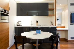 a kitchen with a table and a microwave at Blueprint Living Apartments -Turnmill Street in London