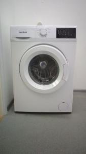 a white washing machine is sitting in a room at "Ваша Квартира" - у самого Дерибаса! "Ваша Квартира" біля самого Дерибаса! in Odesa