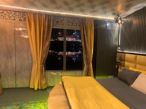 Un dormitorio con una cama amarilla y una ventana. en Messiah’s Ark, en Srinagar