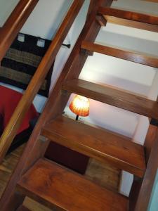 a lamp on the bottom of a wooden staircase at CASA MIKY in Palermo