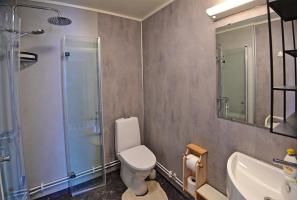 a bathroom with a toilet and a sink and a shower at Rivdnji Holiday Home Smørfjord in Russenes +95 photos