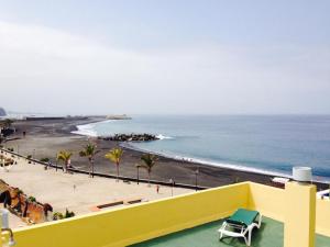 a view of a beach and the ocean from a building at Tazacorte Beach and also Luz y Mar apartments in Puerto