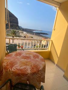 a balcony with a table and a view of the beach at Tazacorte Beach and also Luz y Mar apartments in Puerto