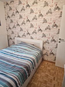 a bedroom with a bed with a wall covered in motorcycle drawings at Apartman LUX BRUS in Brus