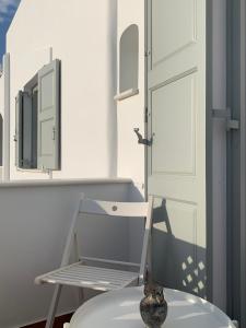 a bathroom with a door and a vase next to a toilet at Sea and Salt Naxos 3 in Kastraki Naxou