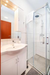 a bathroom with a sink and a shower at Apartments Sandra in Turanj +18 photos