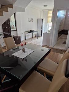 a dining room and kitchen with a table and chairs at Town Square House in Gevgelija