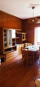 a living room with a table and a kitchen at Georgia's Sweet Home in Nafplio +10 photos