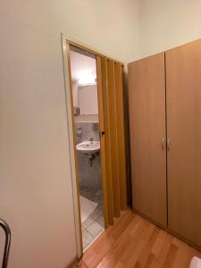 an open door to a bathroom with a sink at Pension Vera in Vienna