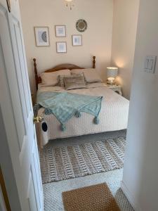 a bedroom with a bed with a table on it at Phare des Dunes Lighthouse in Tracadie