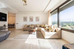 a living room with couches and a large window at Spacious 3 bedroom apartment in Casablanca