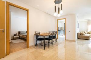 a dining room and living room with a table and chairs at Spacious 3 bedroom apartment in Casablanca