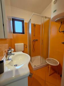 a bathroom with a sink and a shower at Apartments Bevanda in Bale