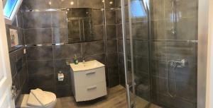 Lizo Hotel في كالكان: حمام مع دش مع حوض ومرحاض