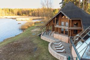 an aerial view of a log cabin on a lake at Lakeside Escape in Suniši
