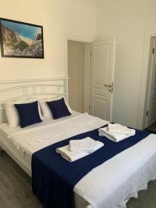 a bedroom with a large bed with towels on it at Lizo Hotel in Kalkan