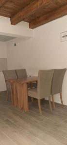 a dining room with a wooden table and chairs at Apartman Vrbas in Jajce +9 photos