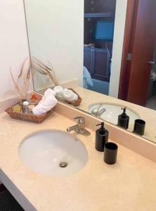 a bathroom counter with a sink and a mirror at Cómodo duplex en centro de Miraflores in Lima