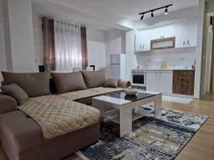 a living room with a couch and a table at Emi Center Apartments in Gevgelija