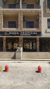 a building with two red balls in front of it at Úplně nový apartmán v Tropical resort in Hurghada