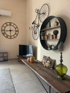 a living room with a table and a bike on the wall at INDUSTRY HOME in Catania +34 photos